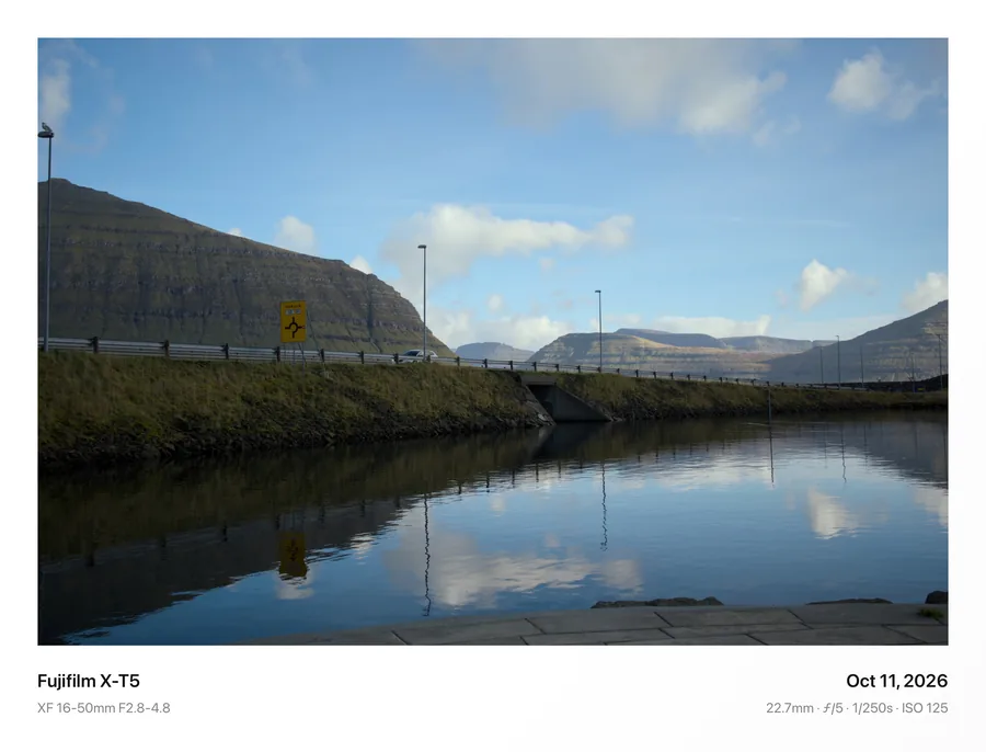 Mountains reflected in still water, framed in Classic